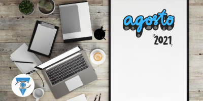 Escritorio con una computadora, un café y plantas